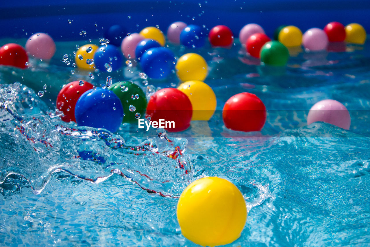 Close-up of multi colored balloons in swimming pool