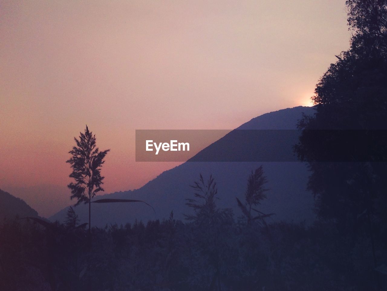 SCENIC VIEW OF MOUNTAINS AT SUNSET