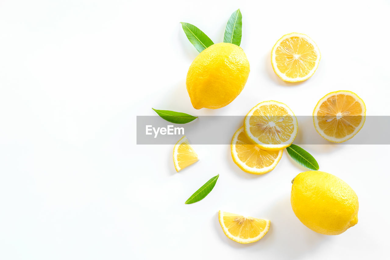 DIRECTLY ABOVE SHOT OF ORANGE FRUITS ON WHITE