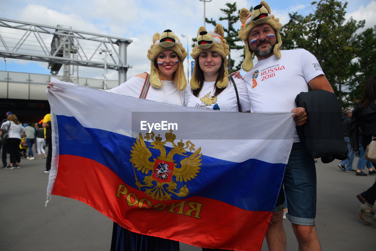 PORTRAIT OF PEOPLE HOLDING FLAG