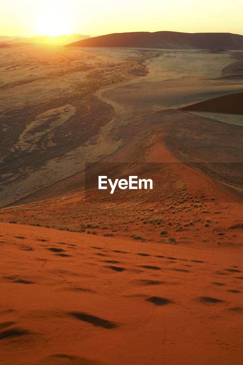 Scenic view of beach against sky during sunset