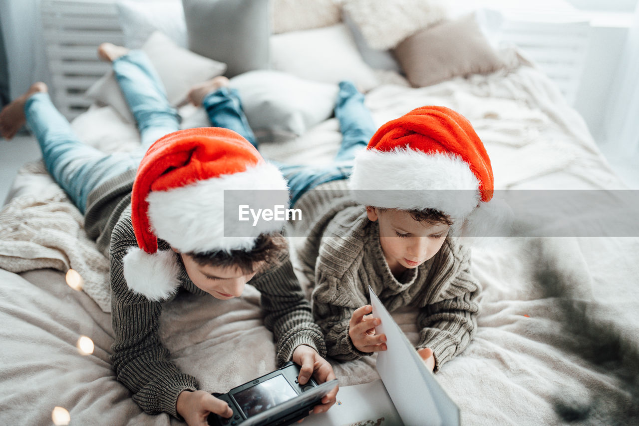 Rear view of mother and daughter in bedroom during winter