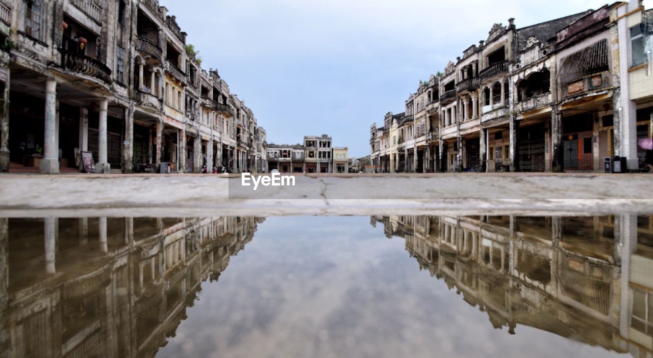 REFLECTION OF BUILDING IN PUDDLE