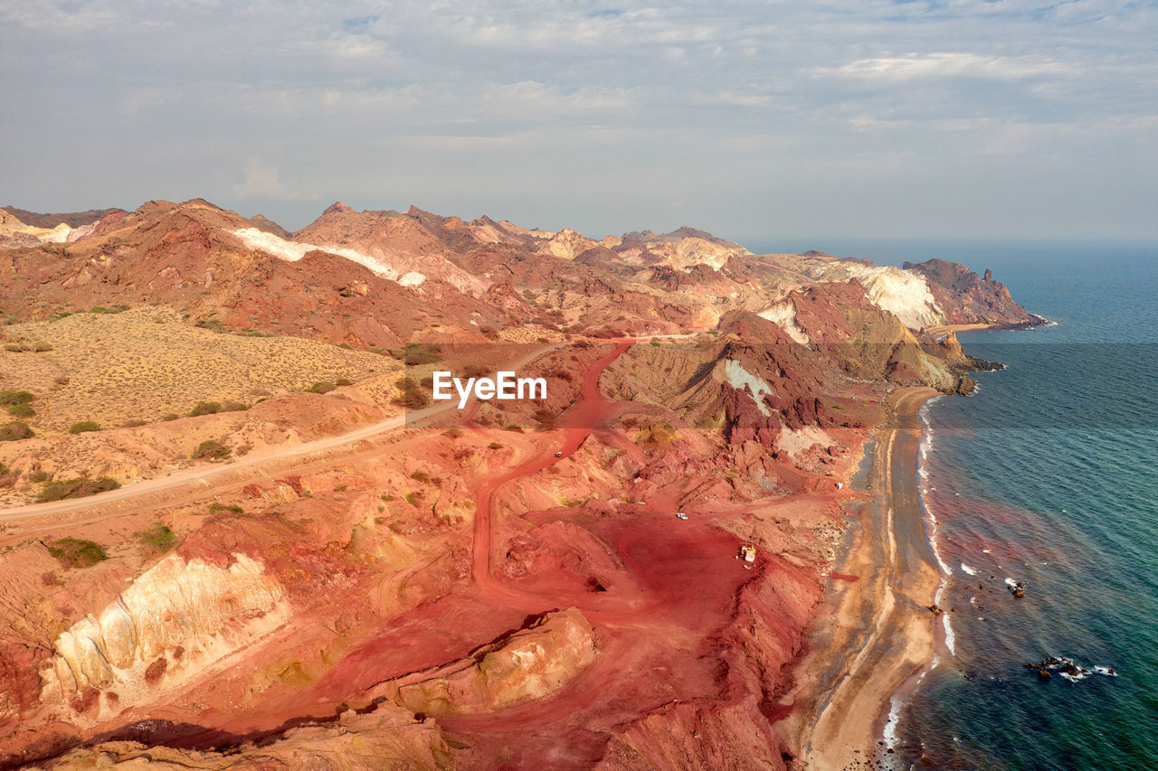 Aerial view of sea and mountains against sky