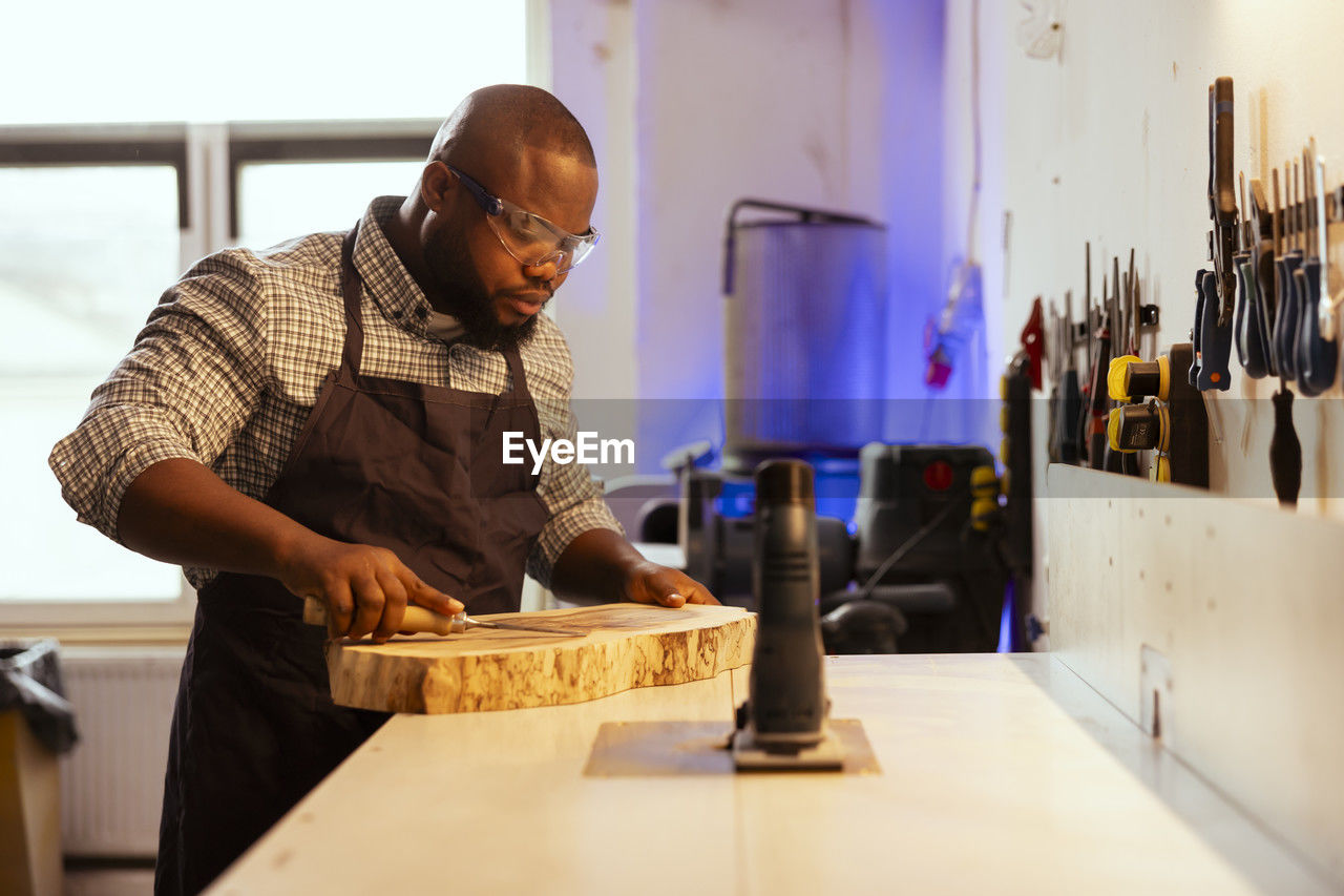 side view of senior man working at table