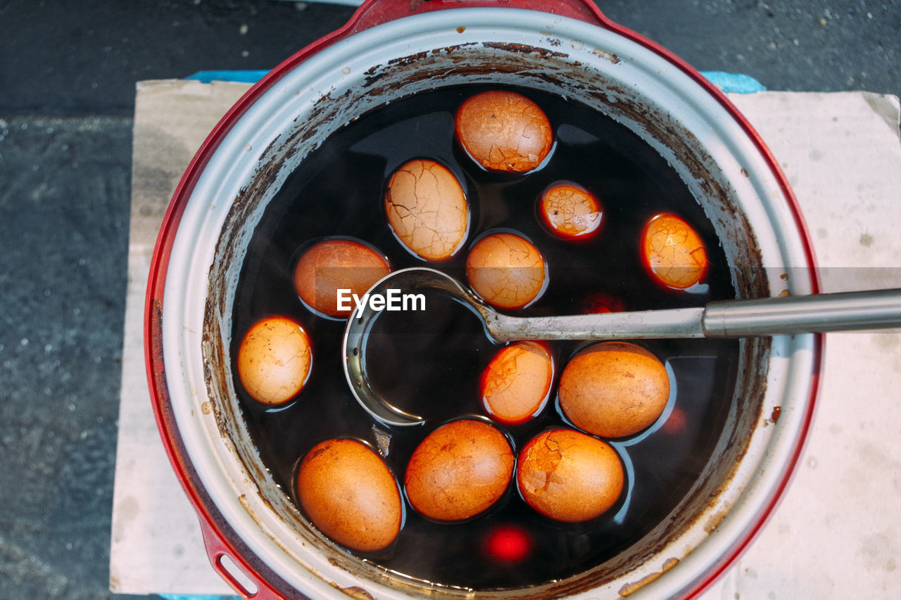 Directly above view of brown eggs in container on table