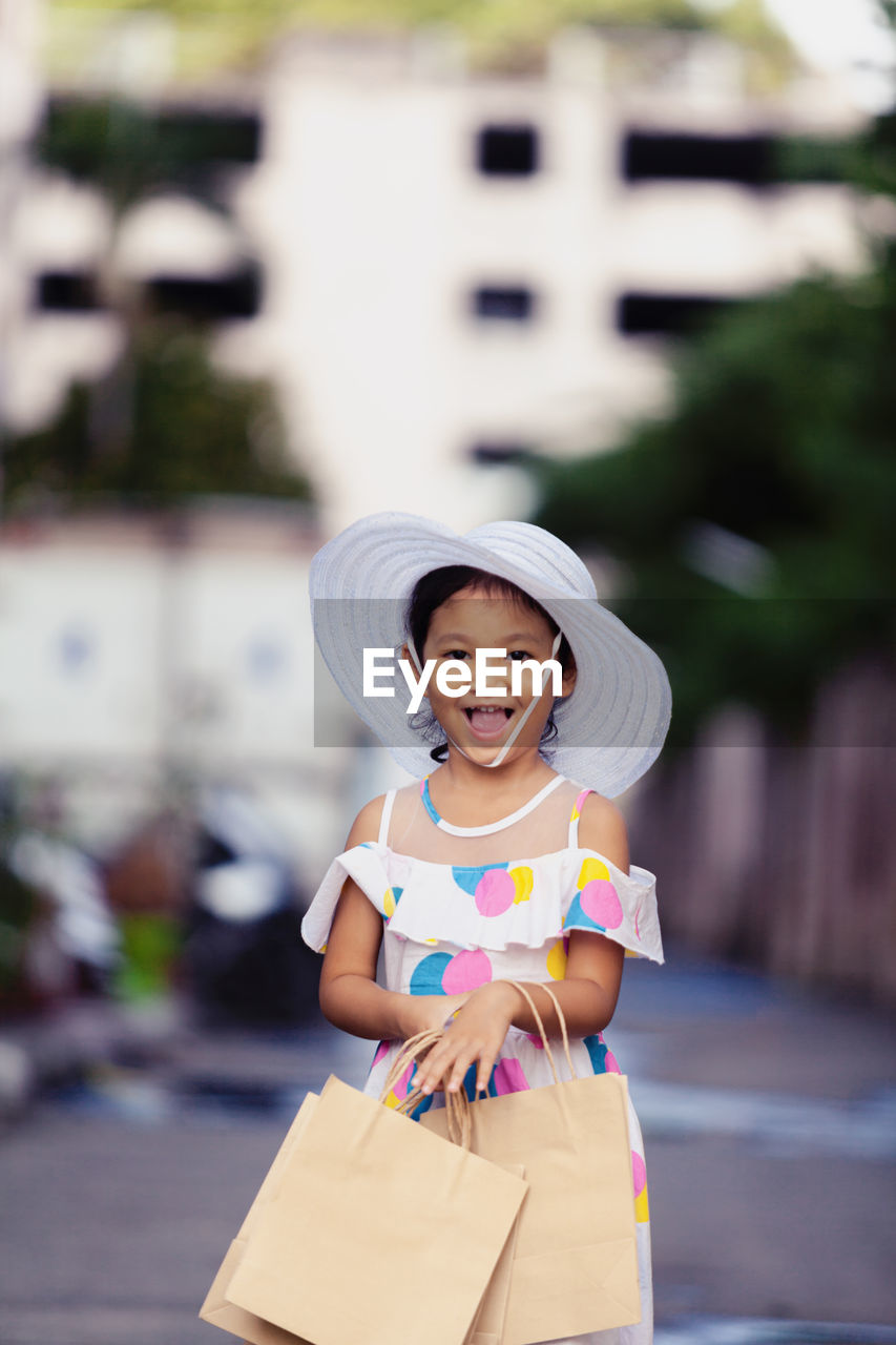 Portrait of cute girl standing outdoors