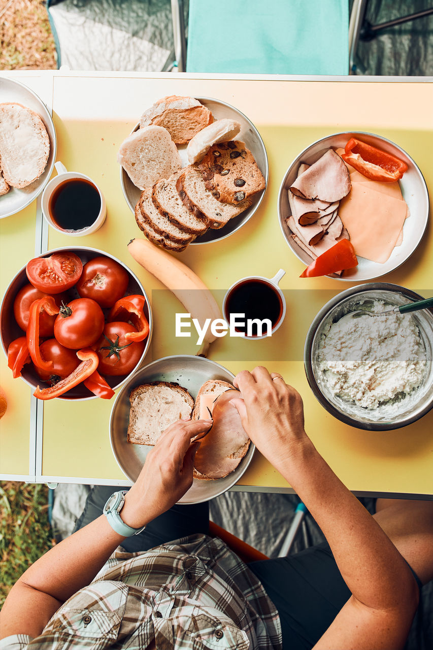 Breakfast prepared during summer vacation on camping. bread, cottage cheese, cold meat