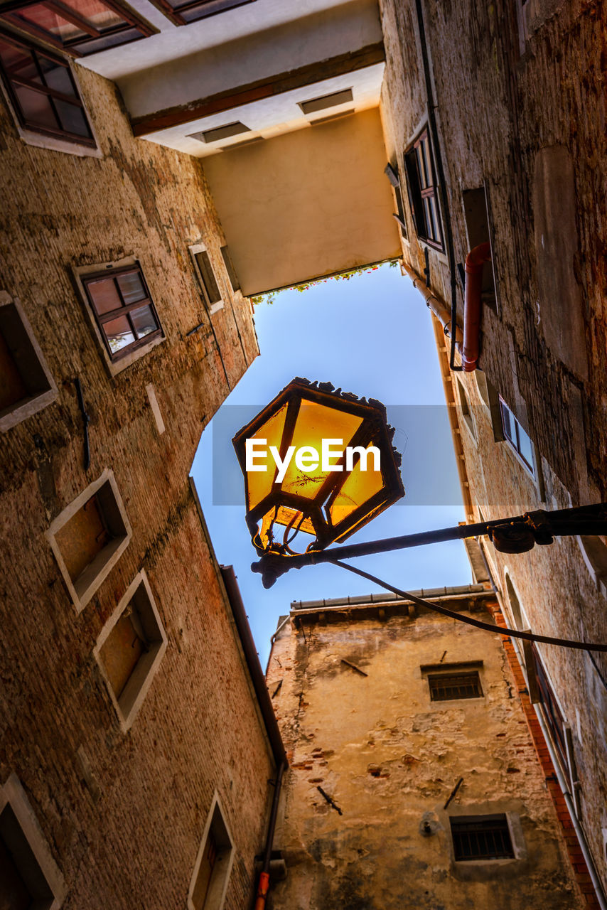 LOW ANGLE VIEW OF YELLOW RESIDENTIAL BUILDINGS