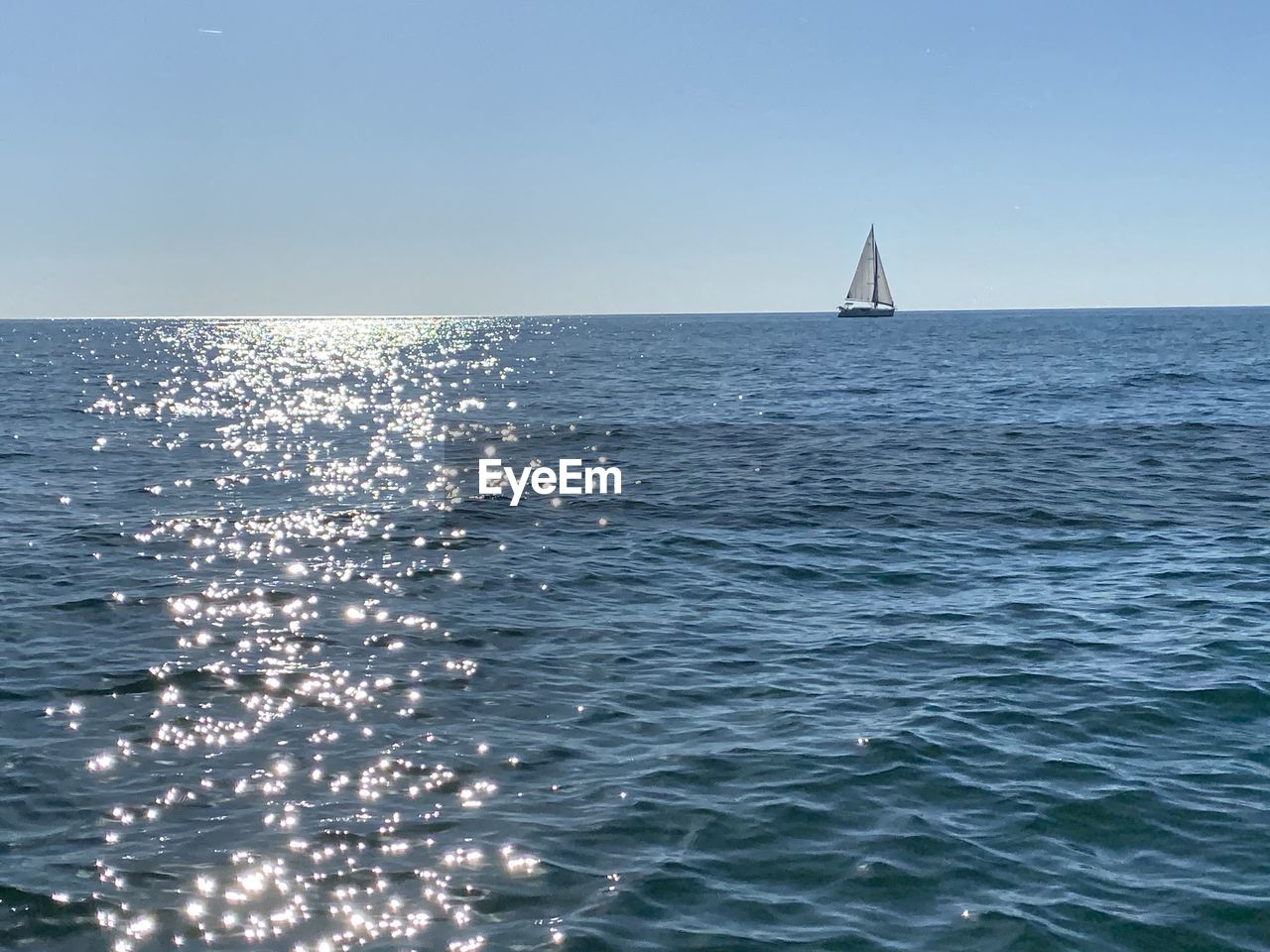 SAILBOATS SAILING ON SEA AGAINST CLEAR SKY