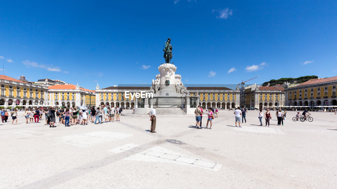 People at praca do comercio against sky
