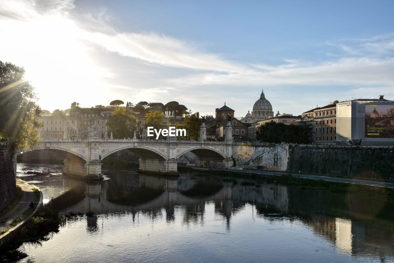 Arch bridge over river against sky