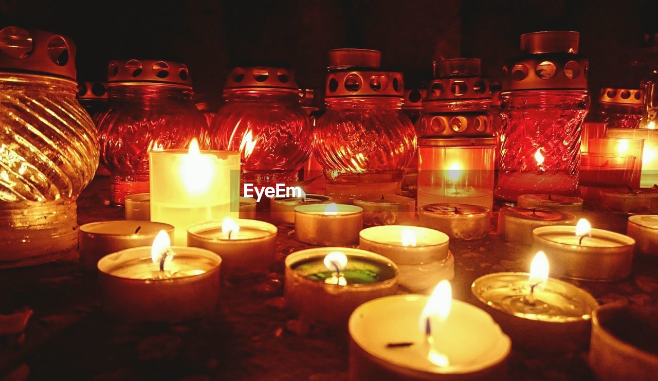 Close-up of lit candles in church