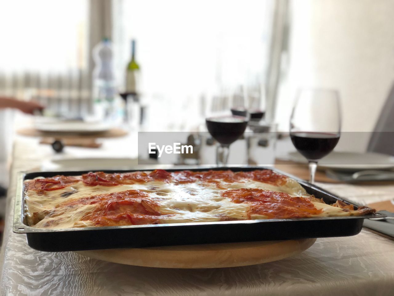 Close-up of pizza in tray on table at restaurant