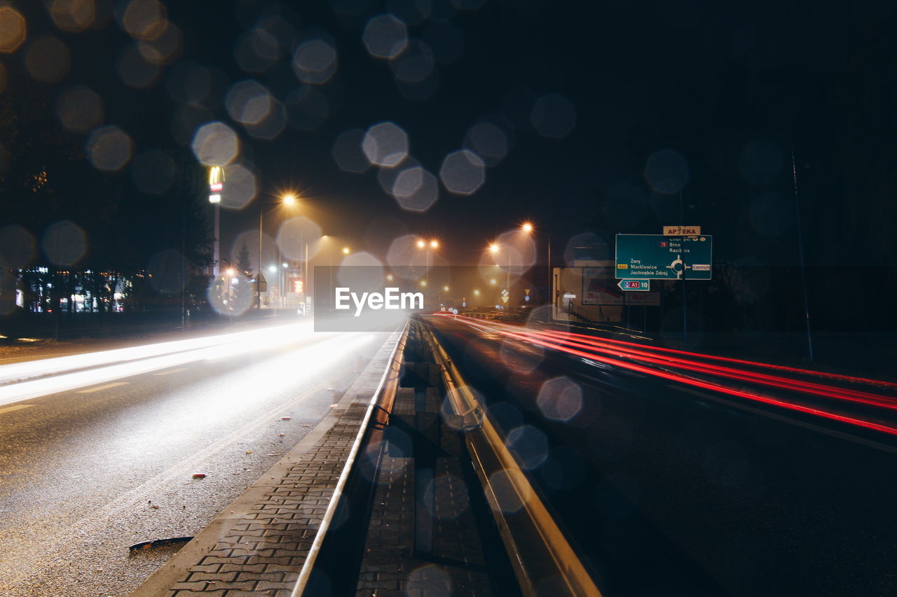 Light trails on road in city at night