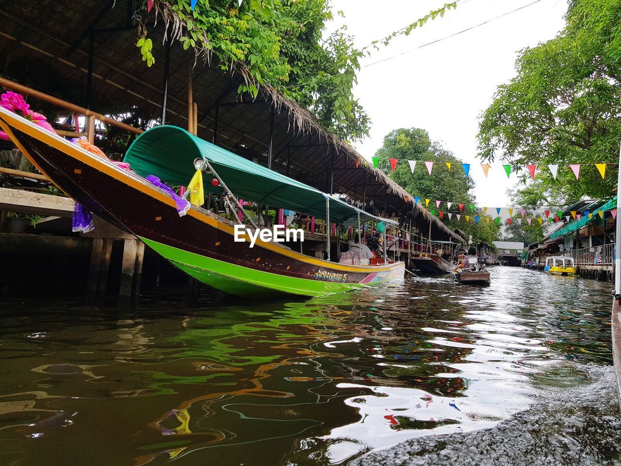 BOATS IN CANAL ALONG TREES