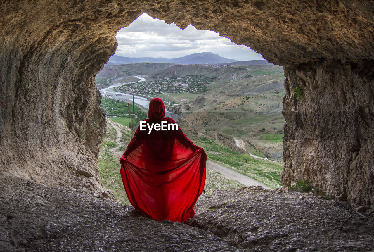 Rear view of woman standing on rock