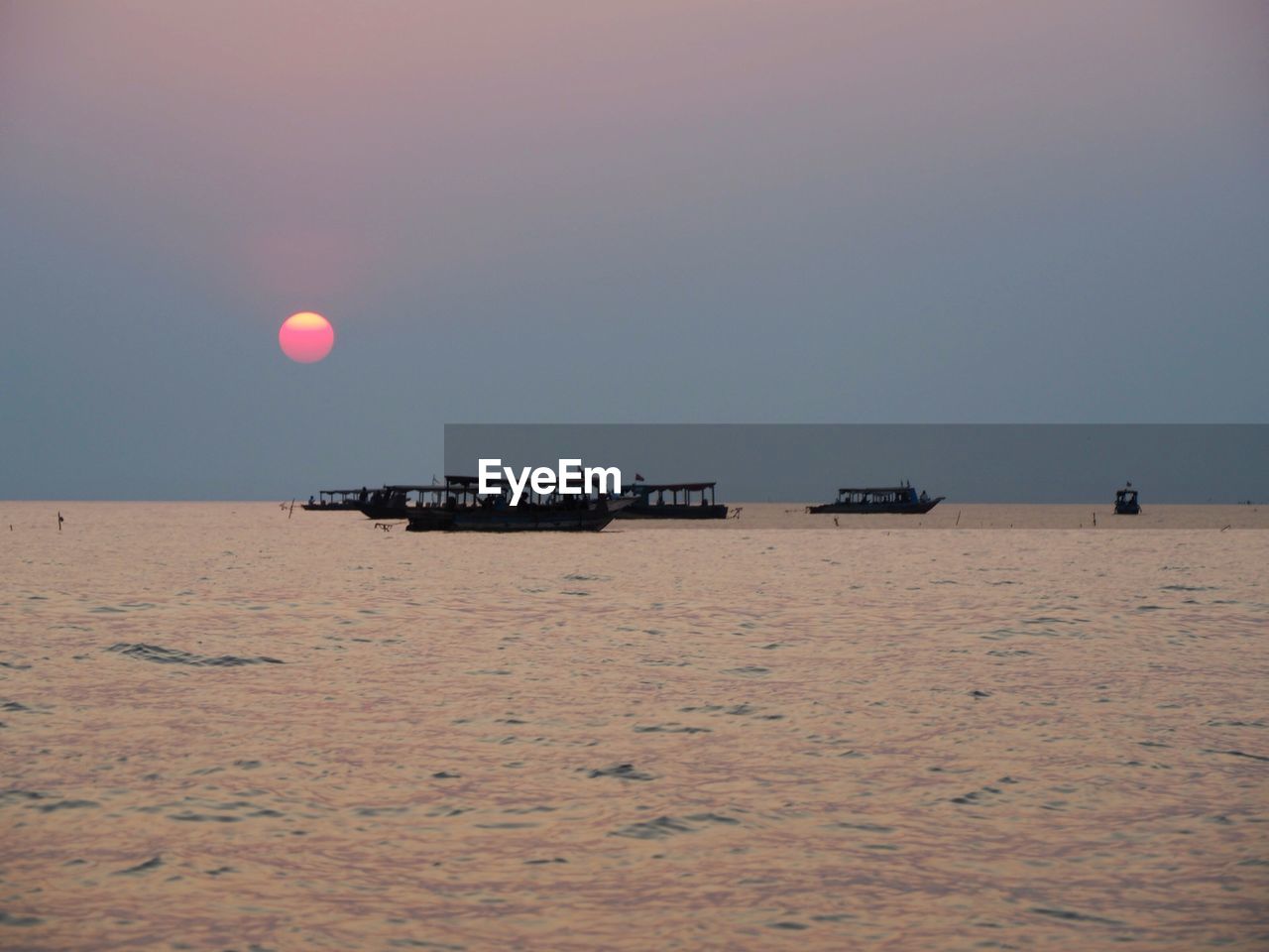 Scenic view of sea against clear sky during sunset