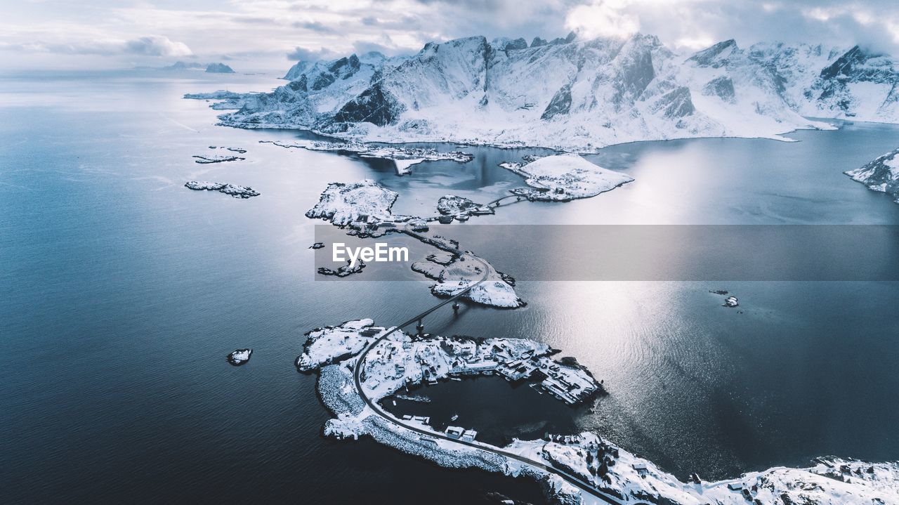 Aerial view of frozen sea and snowcapped mountains during winter