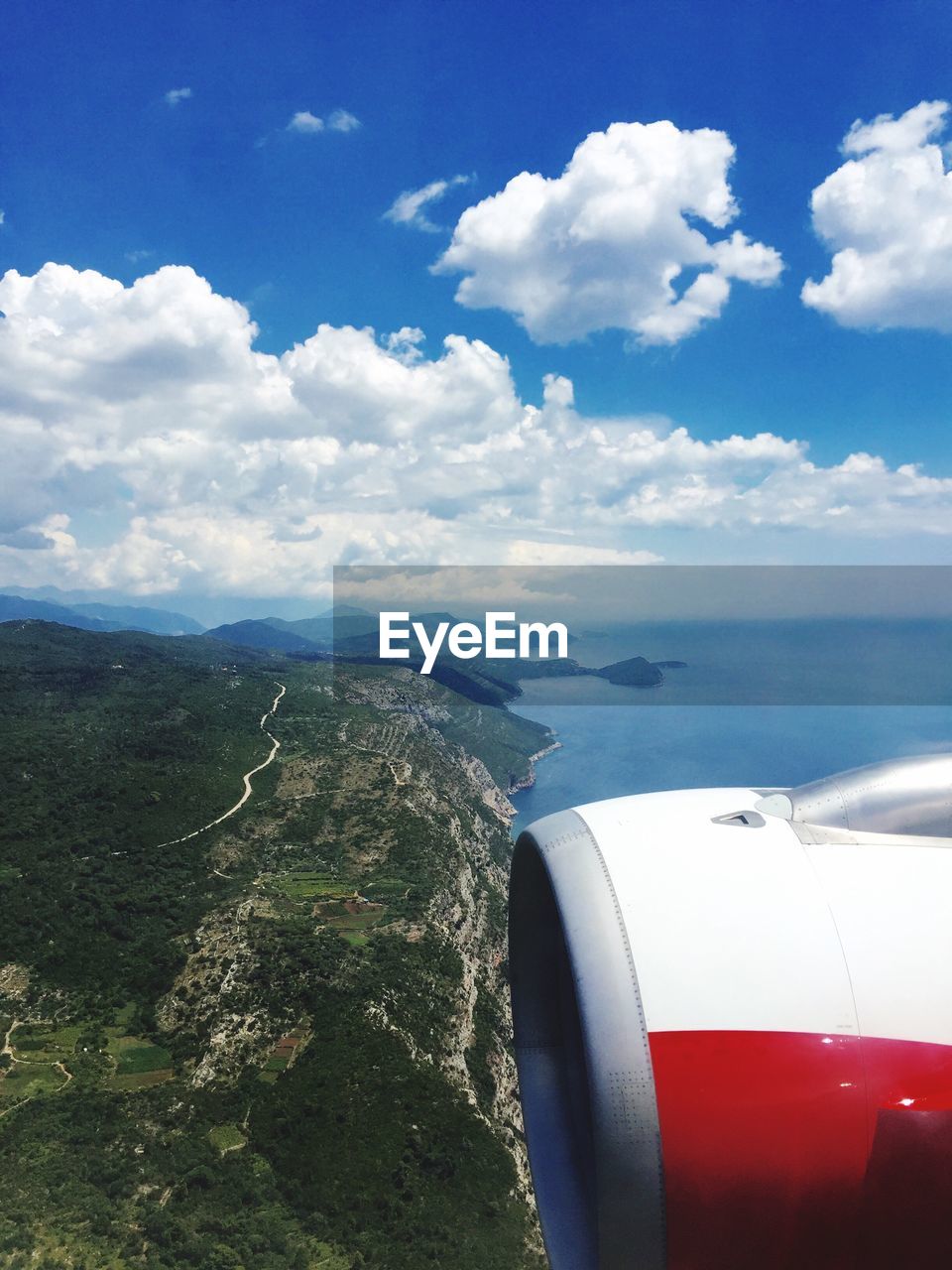 Close-up of airplane wing over sea against sky