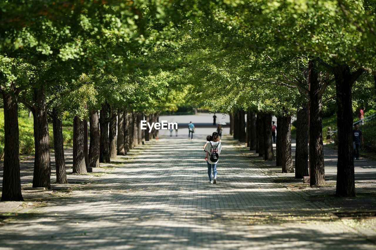 MAN WALKING ON NARROW LANE