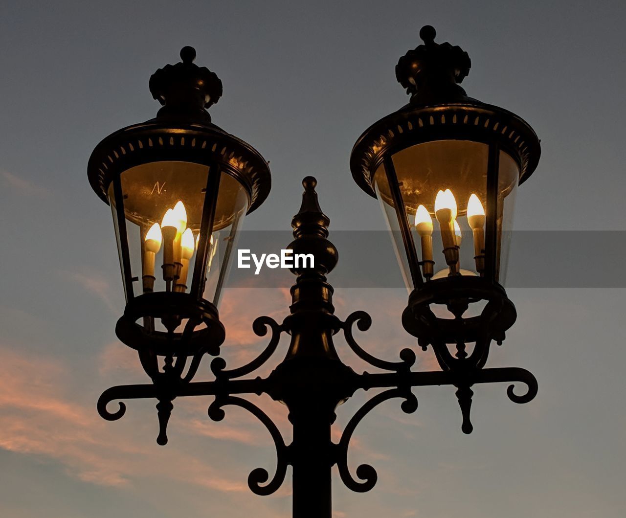 Two old-fashioned lanterns at twilight