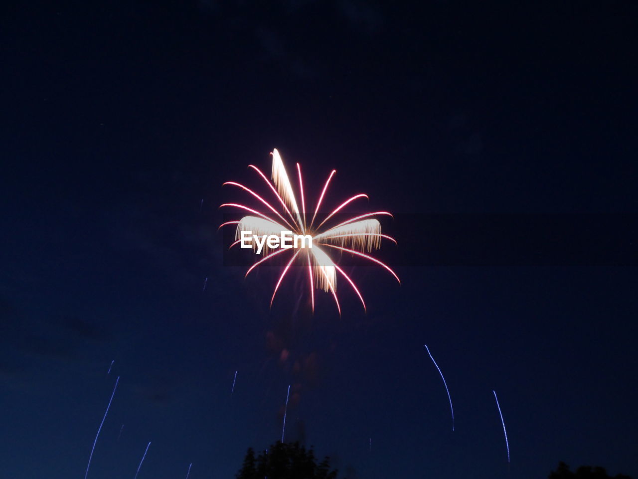 LOW ANGLE VIEW OF FIREWORK DISPLAY AT NIGHT