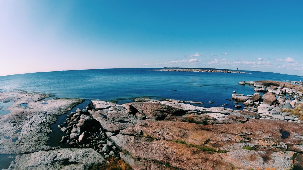 Scenic view of sea against blue sky