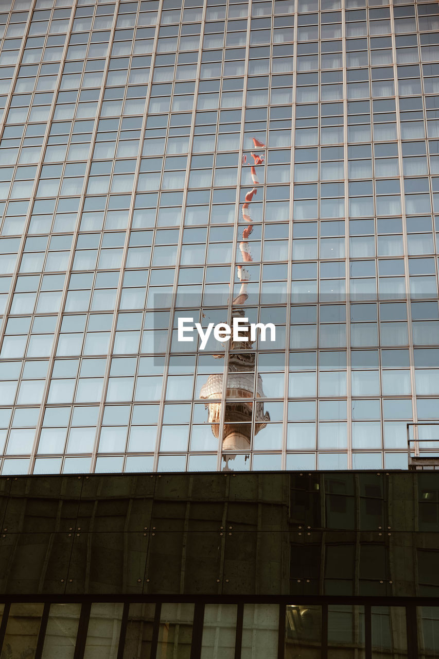 Reflection of fernsehturm on glass building