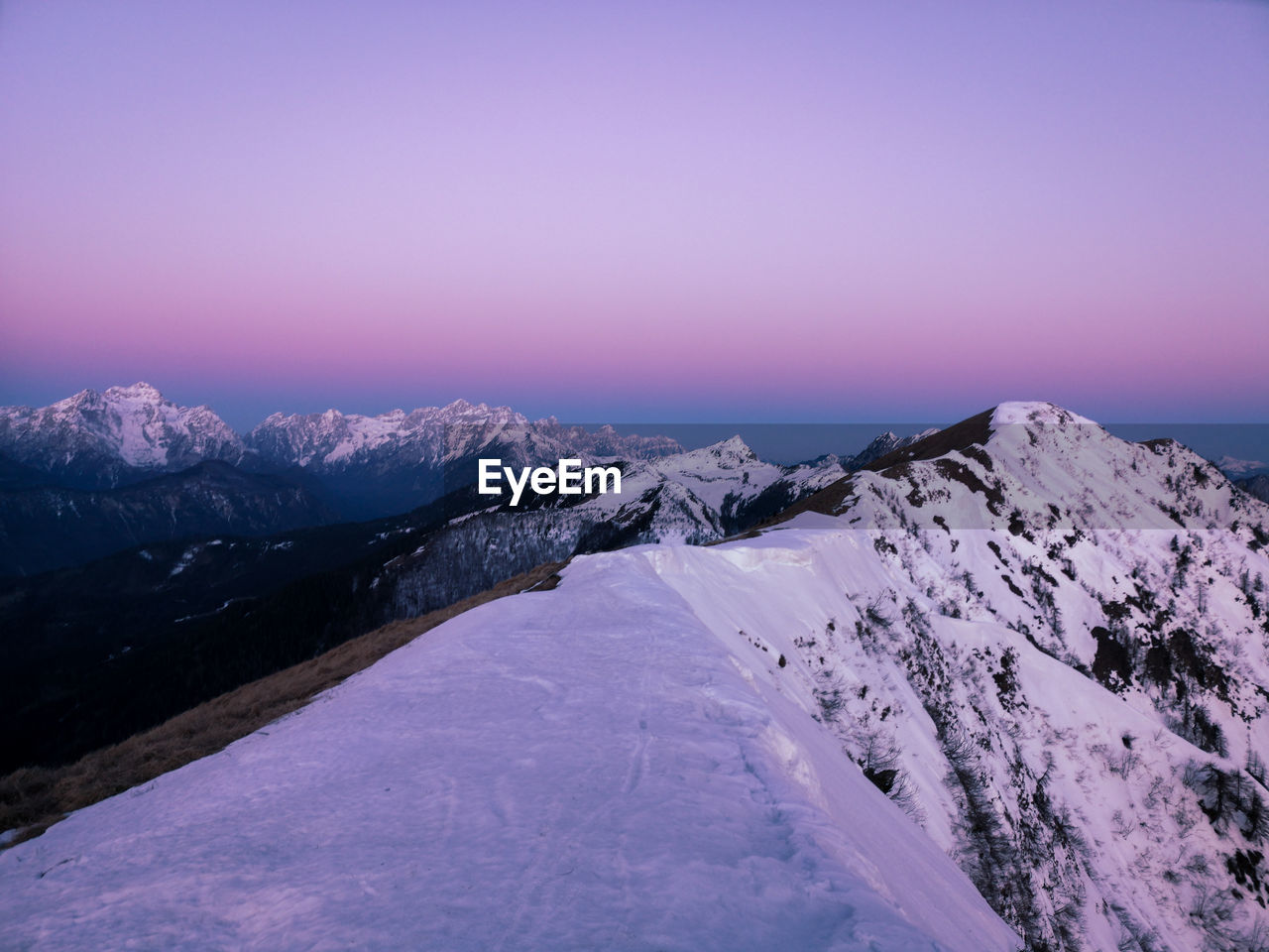 Scenic view of snowcapped mountains against sky during winter