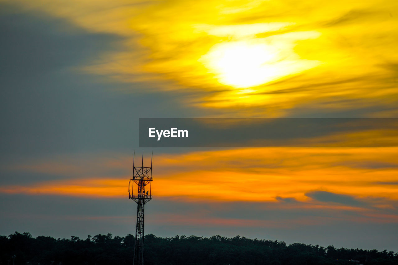 silhouette crane against orange sky