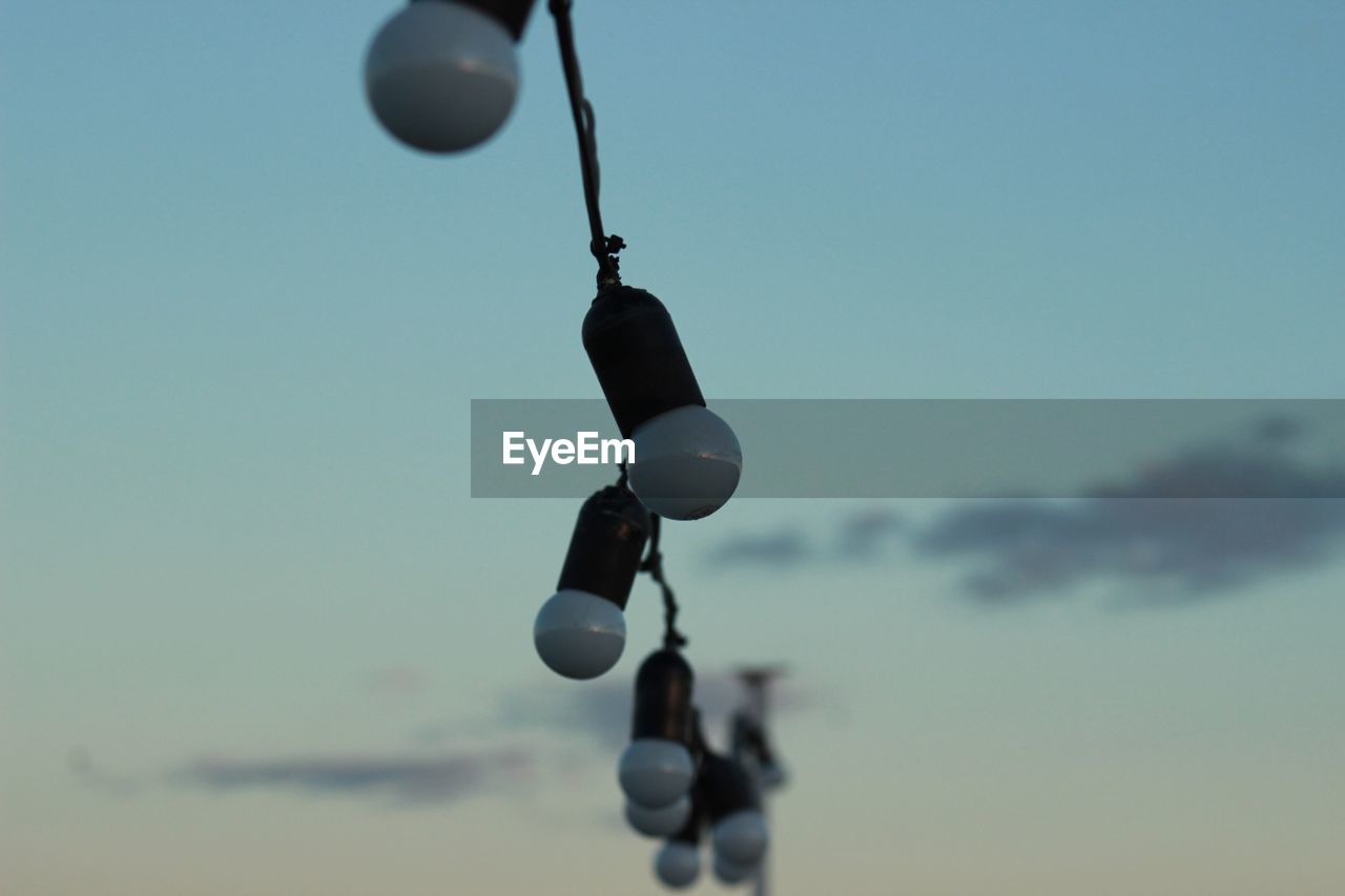 Low angle view of lights against sky