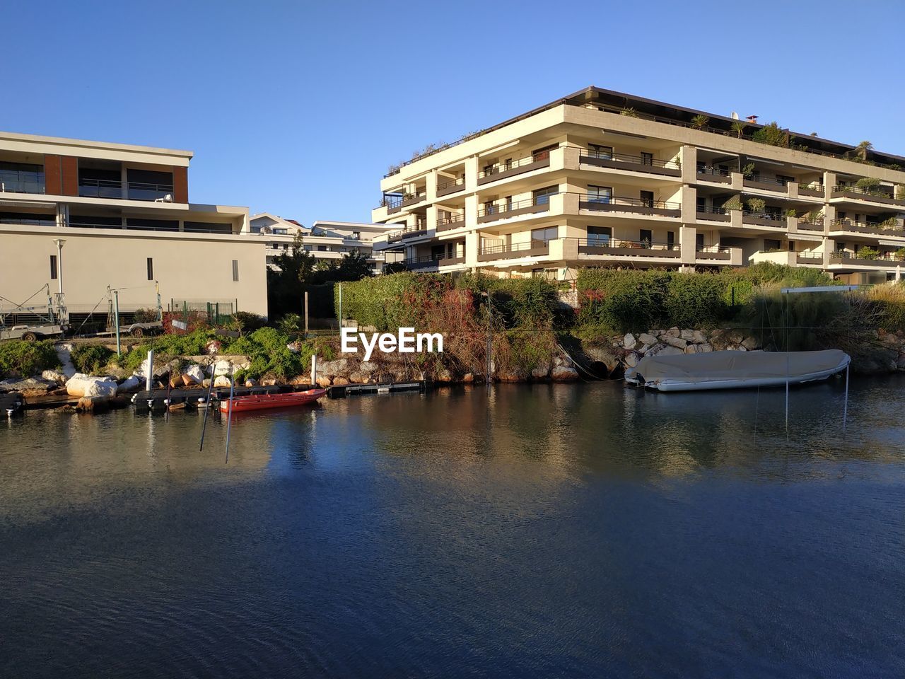 RIVER BY BUILDING AGAINST CLEAR SKY