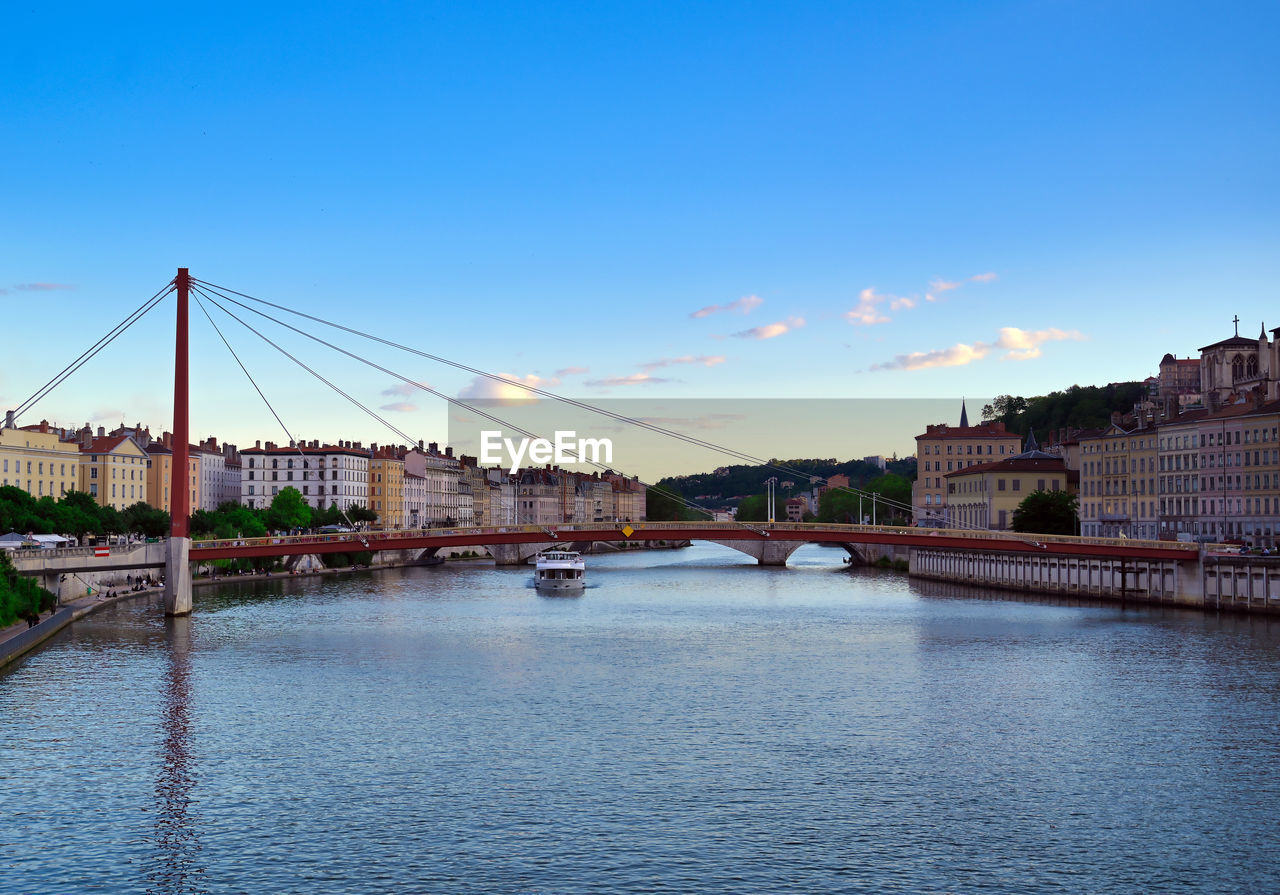 BRIDGE OVER RIVER AGAINST BUILDINGS