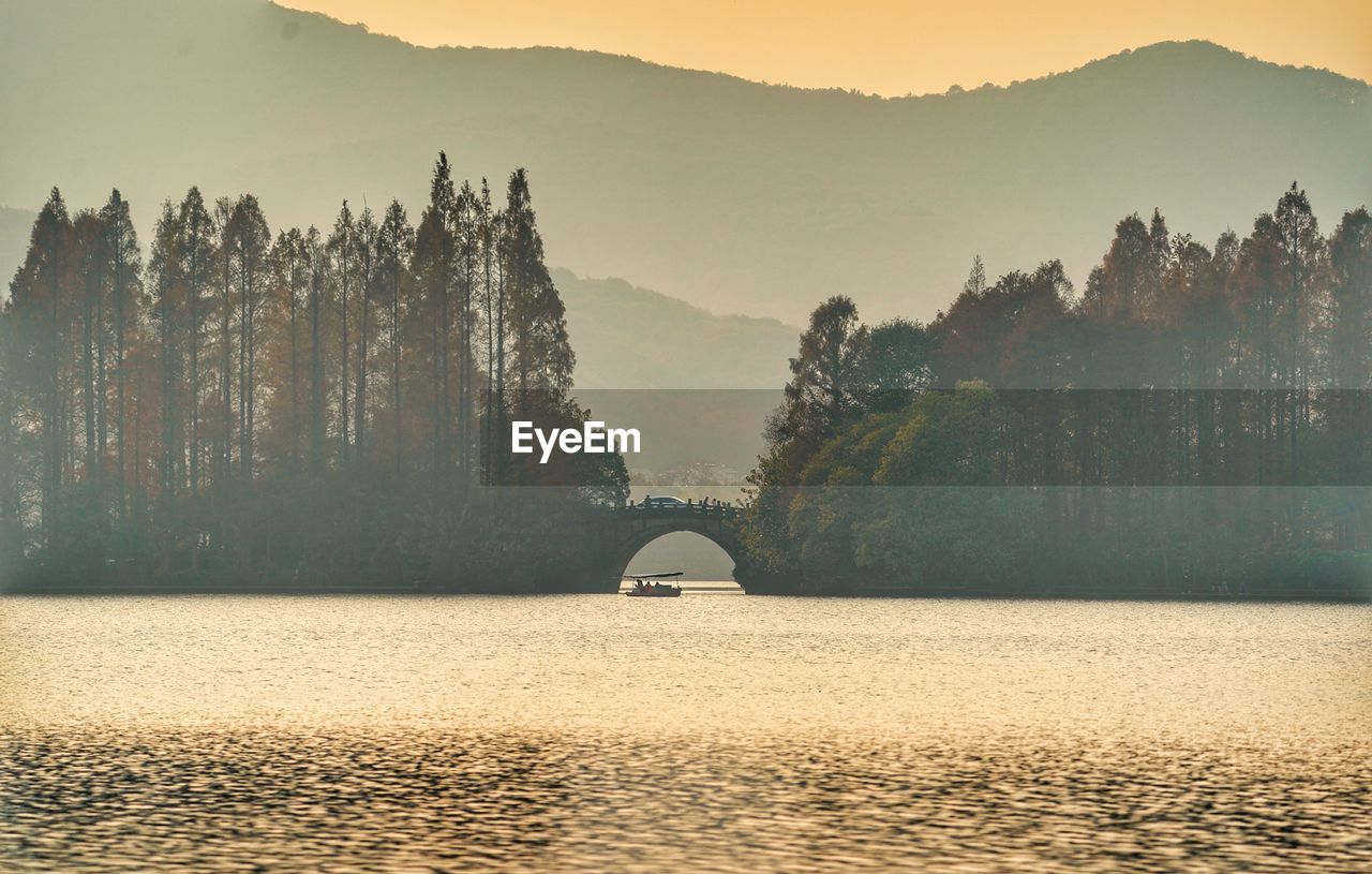 Scenic view of river and mountains against sky