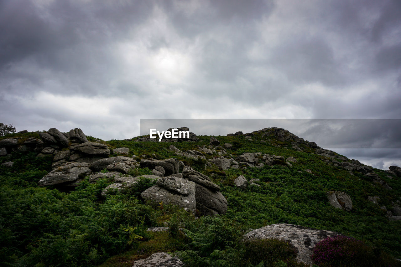 ROCKS ON MOUNTAIN AGAINST SKY