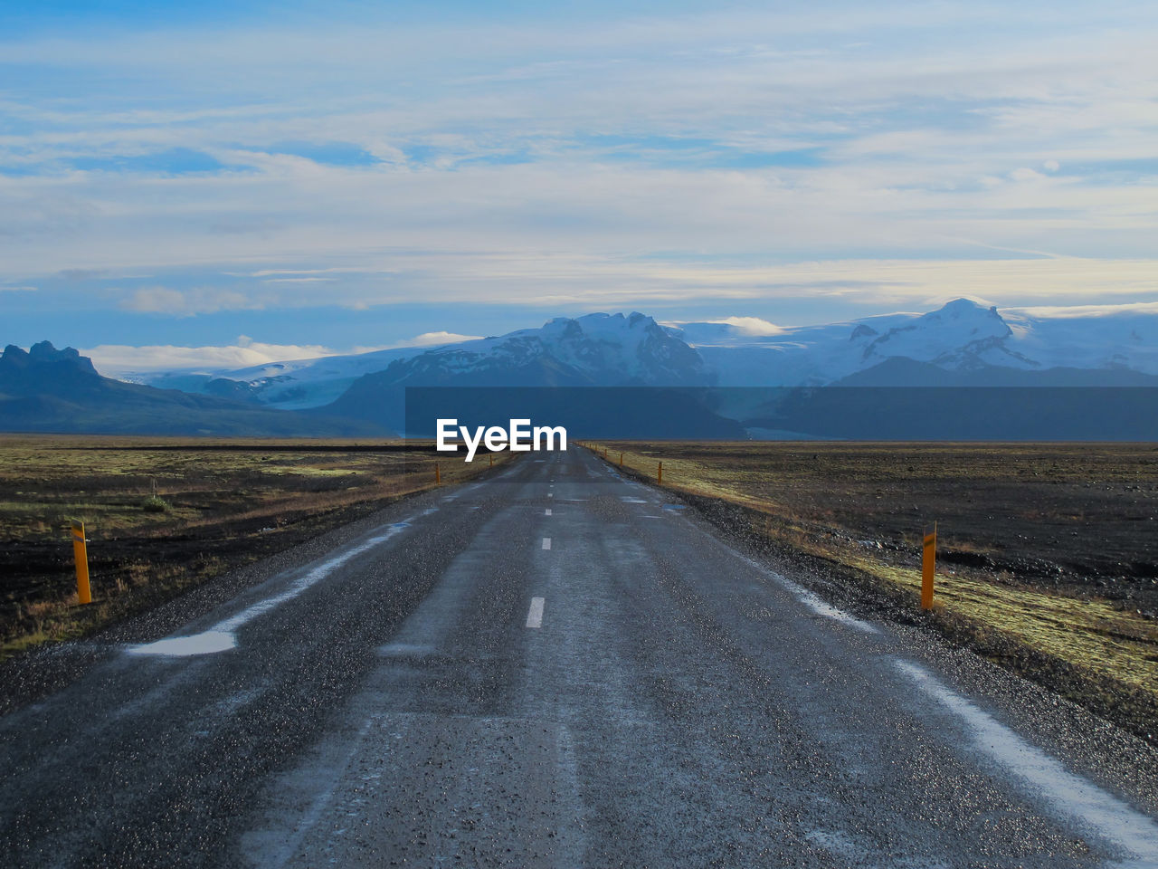 Empty road along countryside landscape