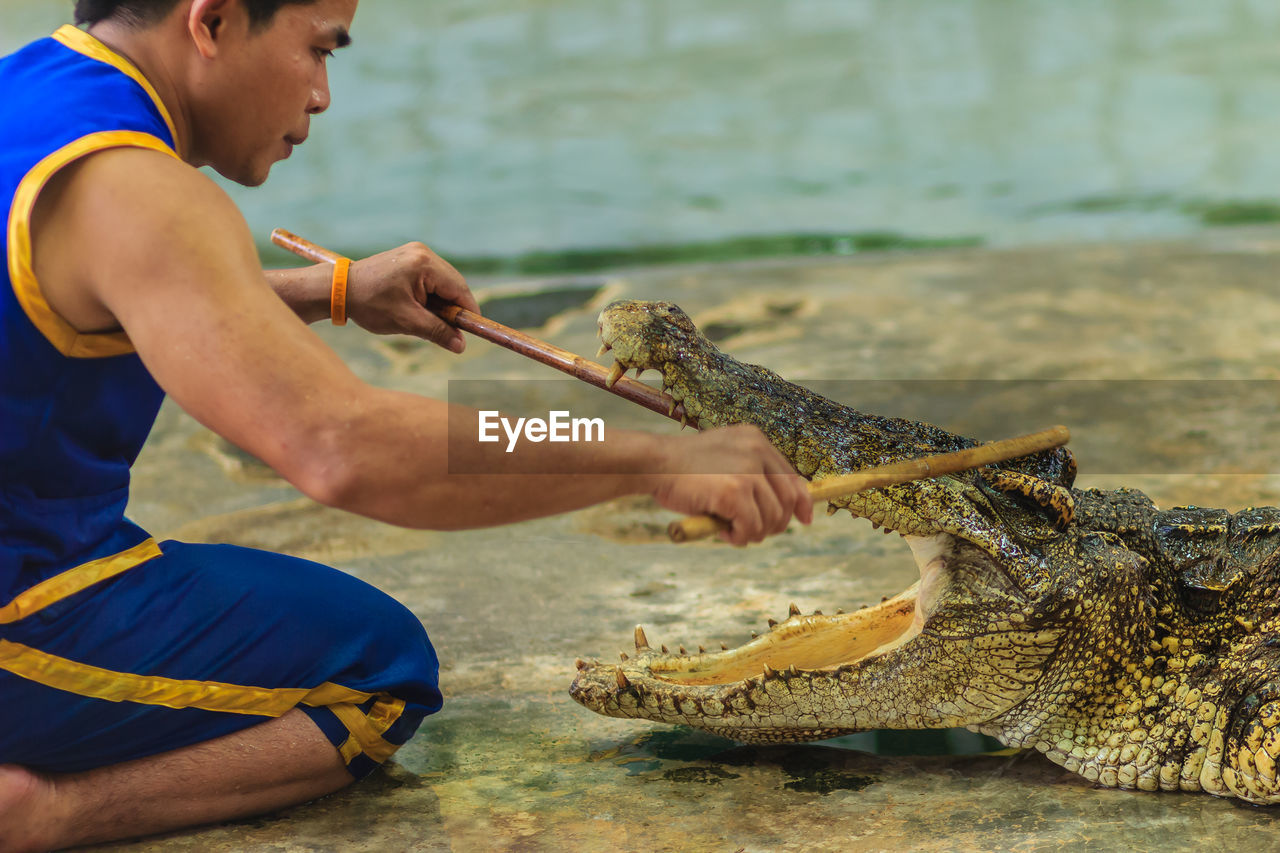 SIDE VIEW OF A MAN FISHING