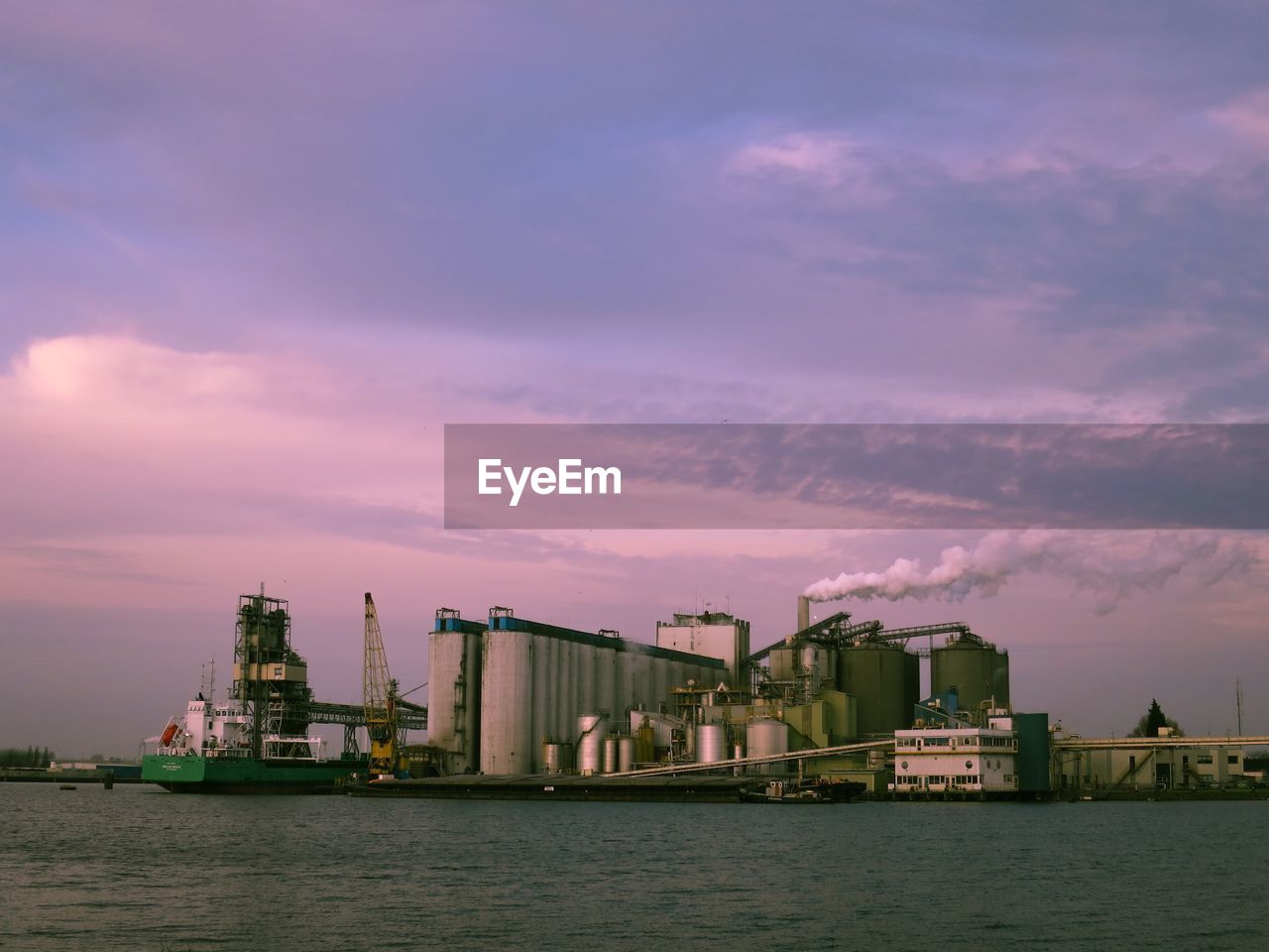 Commercial dock by sea against sky