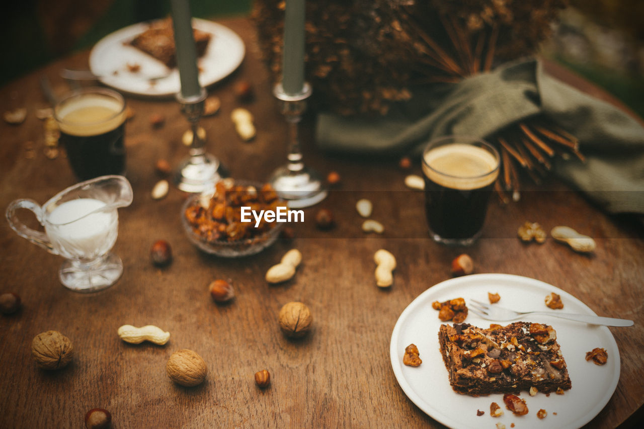 High angle view of nut brownies and coffee on wood table