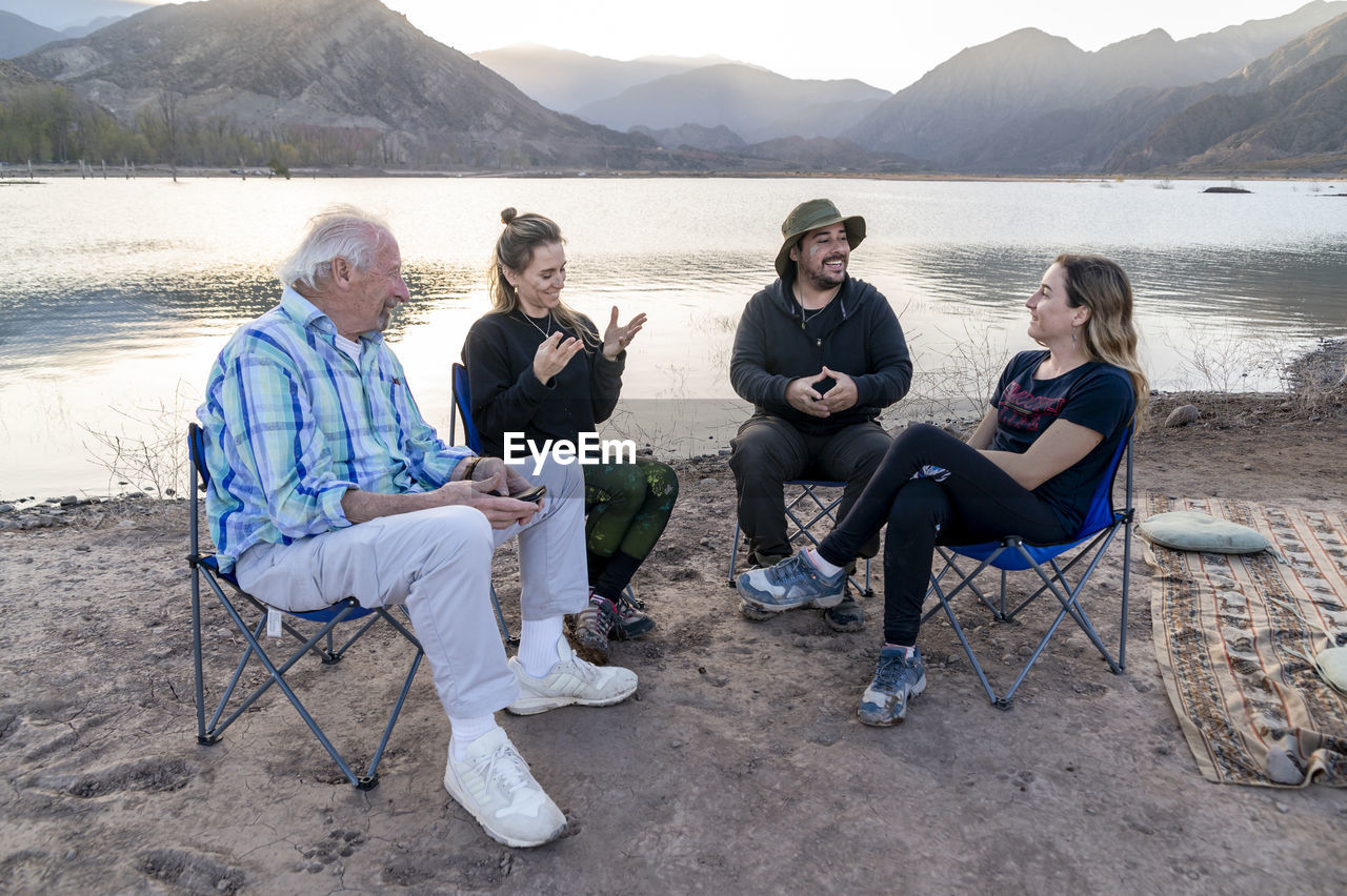 Family enjoying time together while relaxing outdoors in nature.