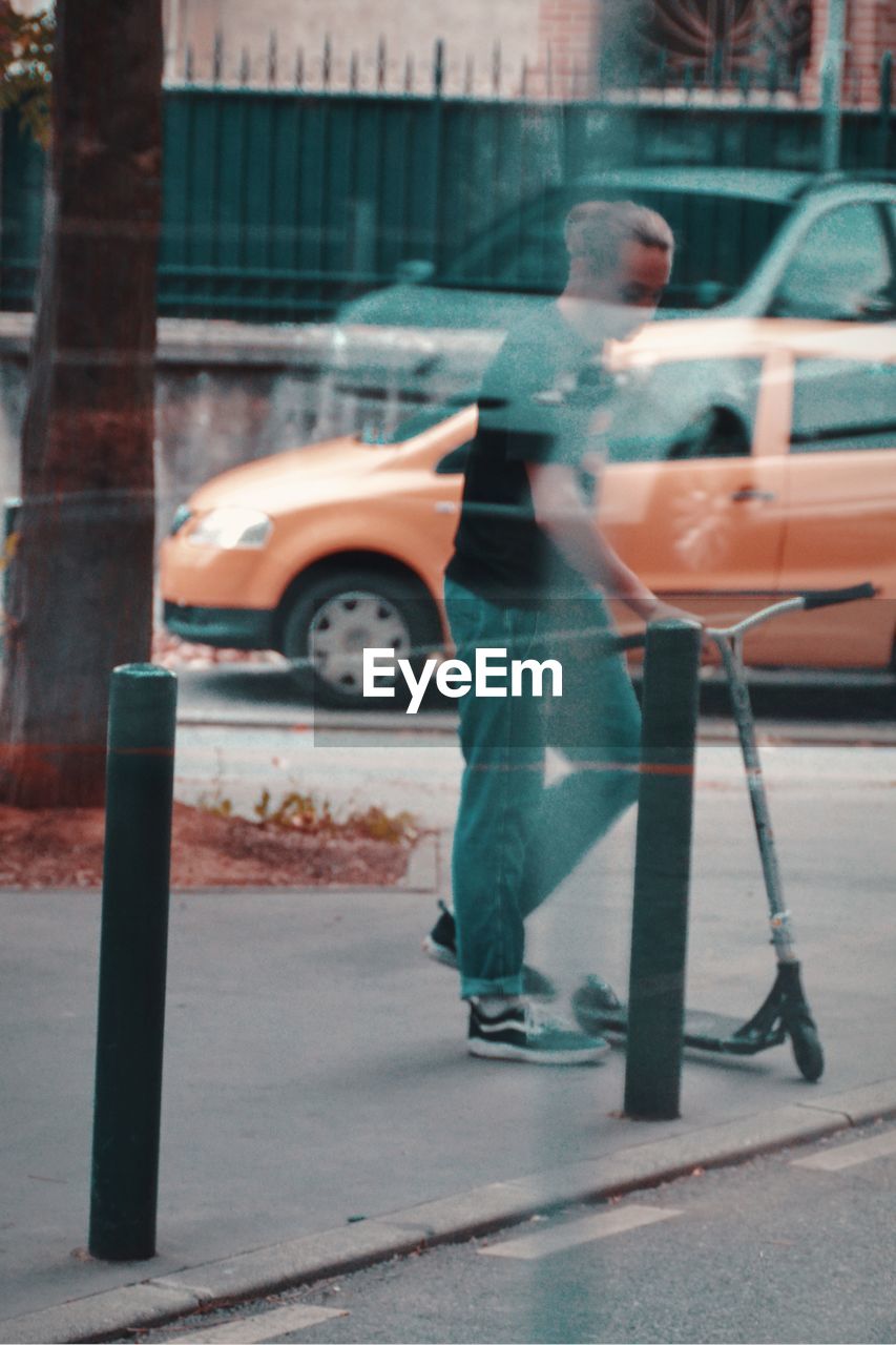 MAN STANDING ON STREET