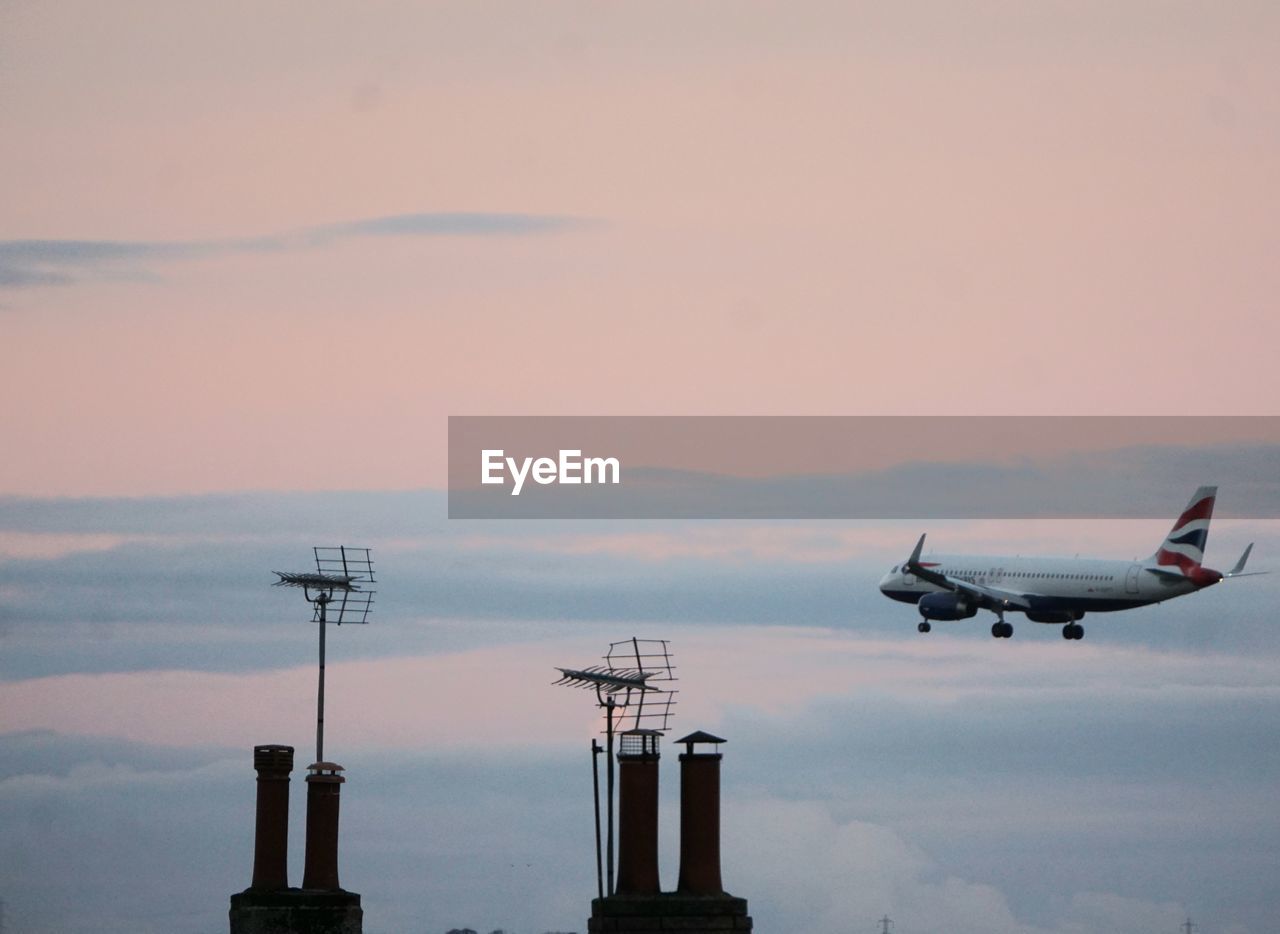 transportation, sky, air vehicle, mode of transportation, airplane, sunset, flying, nature, cloud, aircraft, vehicle, no people, travel, technology, aviation, architecture, outdoors, airport, business finance and industry, airliner, horizon, dawn