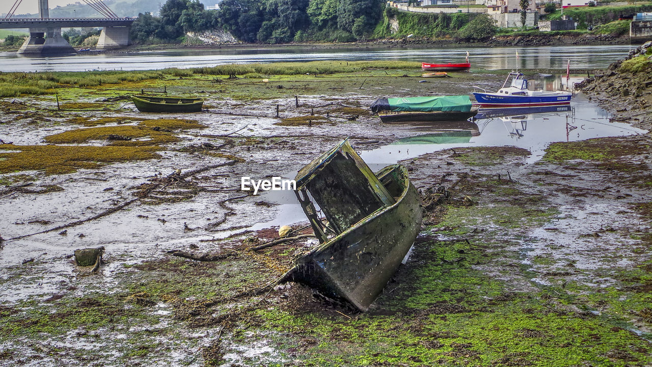 Boats moored at riverbank