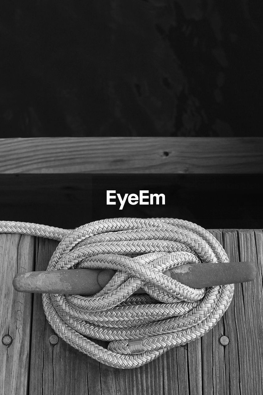 High angle view of rope tied up of bollard by river