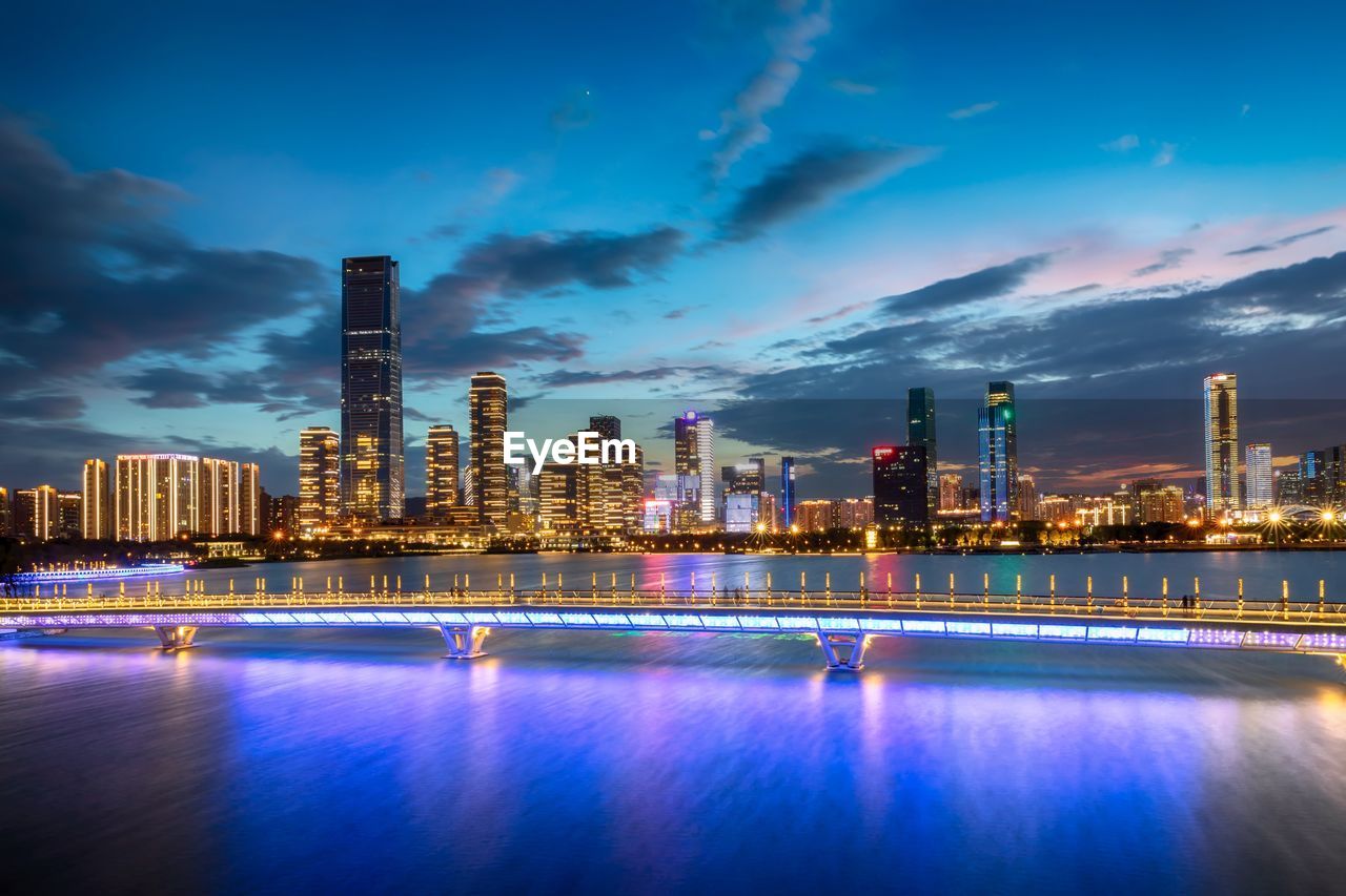 Illuminated buildings against sky at night