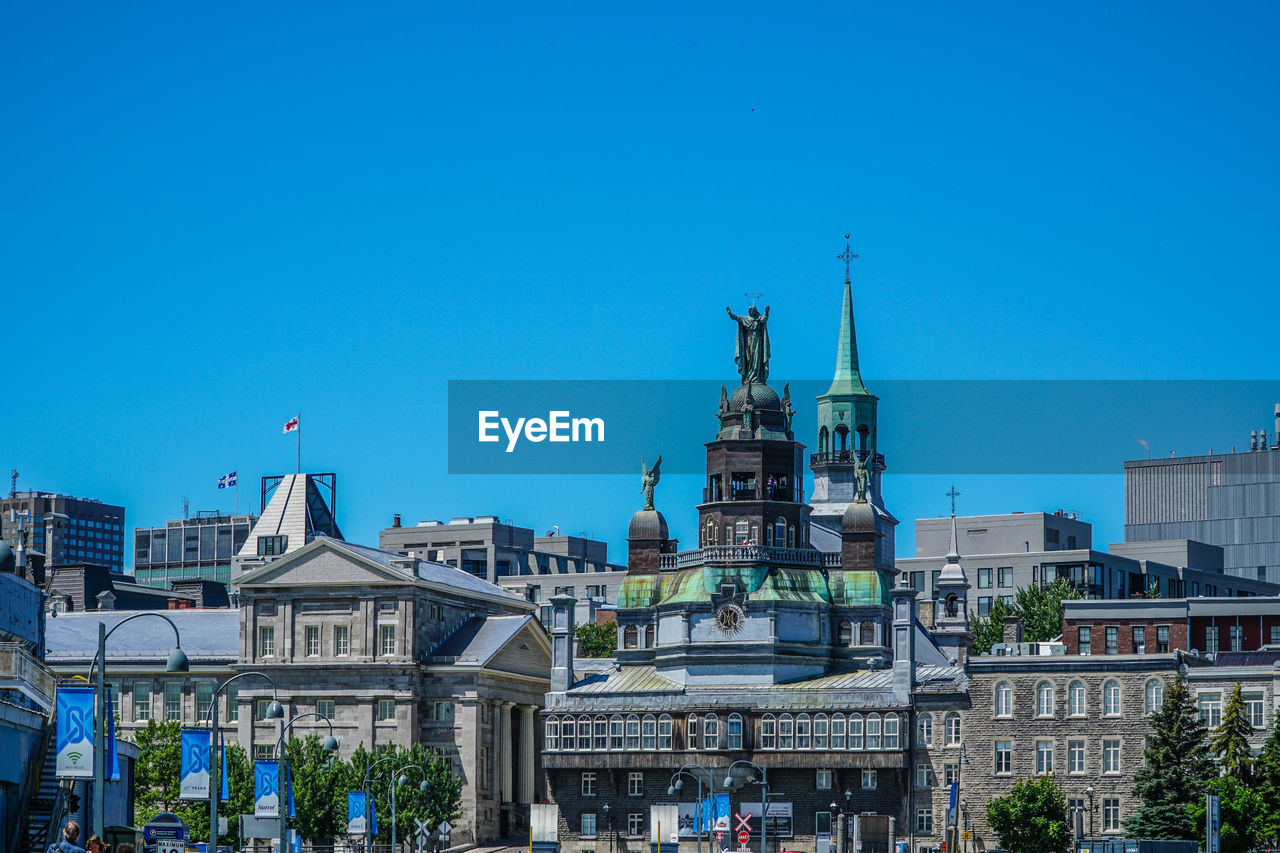 VIEW OF BUILDINGS AGAINST BLUE SKY