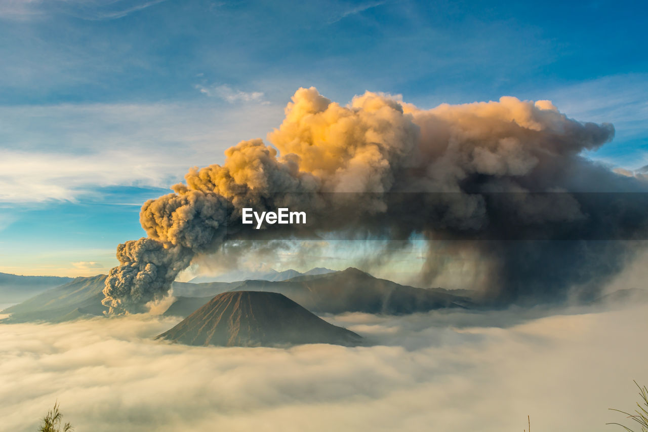 Smoke emitting from volcanic bromo mountain against sky