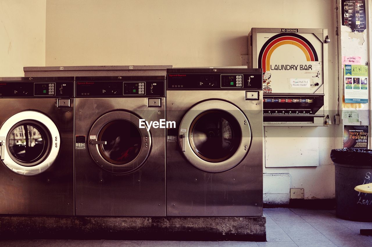 Close-up of washing machines in laundromat