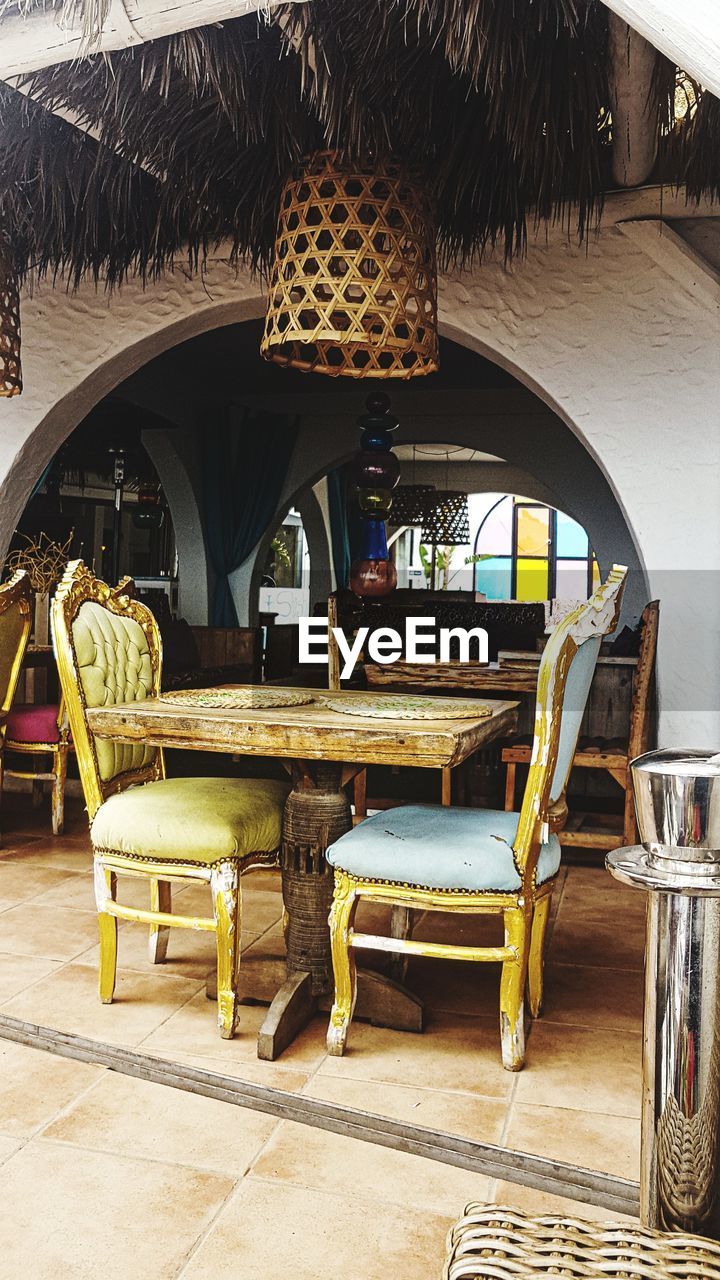 EMPTY CHAIRS AND TABLE IN CAFE